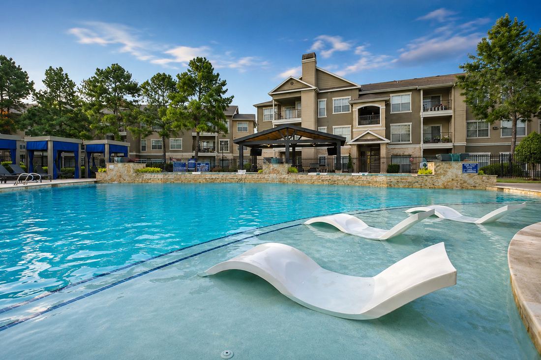 Pool with in-water lounge chairs and clubhouse